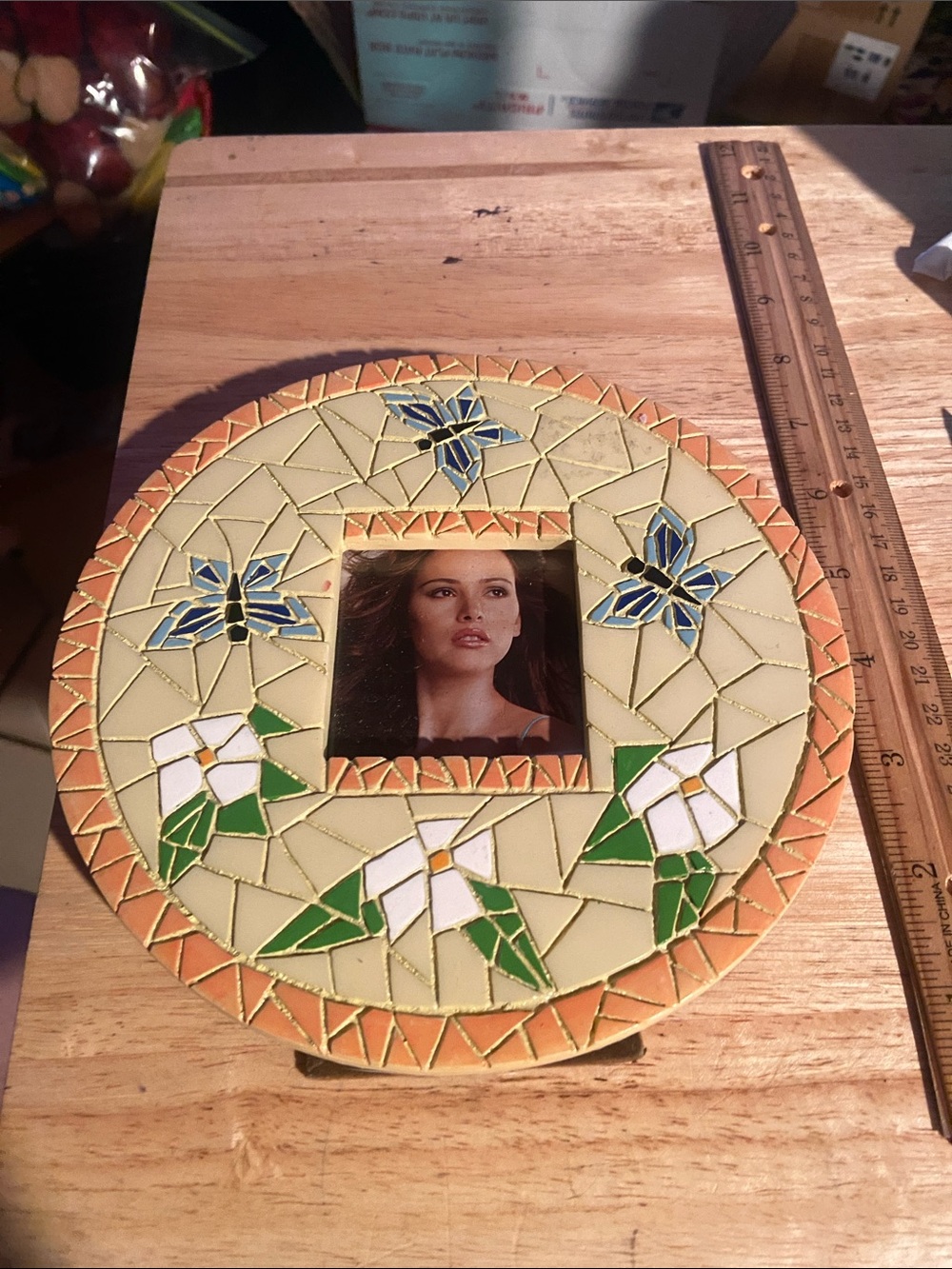 This Vintage Mosaic Style Photo Frame features a cream-colored round design
